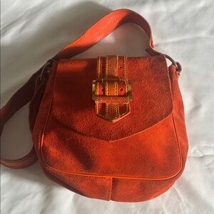 Vintage, if not antique, killer orange suede shoulder bag .